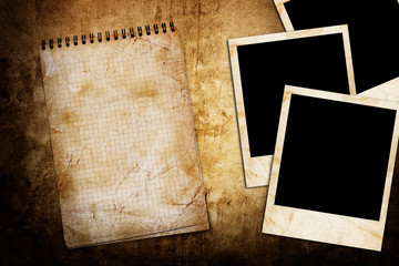 old used notebook on grunge background with photo frame