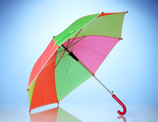 Multi-colored umbrella on blue background