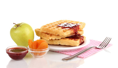 Tasty waffles with jam on plate isolated on white