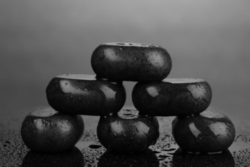 Fototapeta na wymiar Spa stones with water drops on grey background