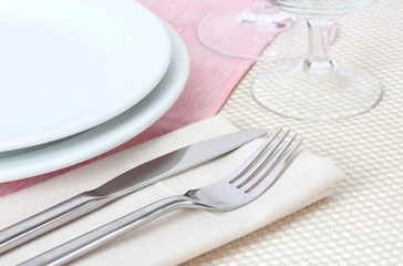 Table setting with fork, knife, plates, and napkin