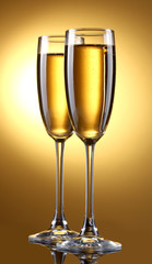 glasses of champagne on yellow background
