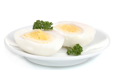 tasty boiled eggs and parsley on plate isolated on white