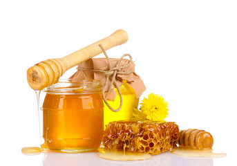 two jars of honey, honeycombs and wooden drizzler isolated