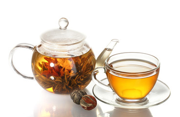 exotic green tea with flowers in glass teapot and cup isolated