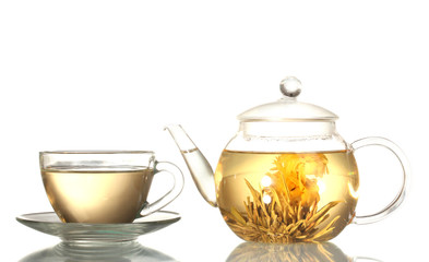 exotic green tea with flowers in glass teapot and cup isolated