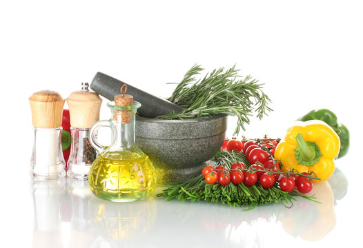 rosemary in mortar, oil in jar, paprika, tomatoes cherry, and