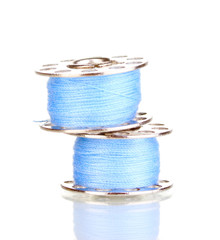 Metal spools of thread isolated on white