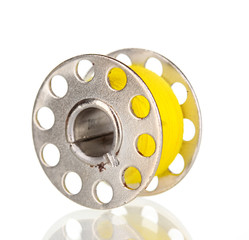 Metal spool of thread isolated on white