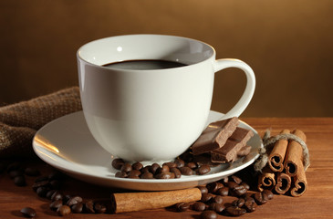 cup of coffee and beans, cinnamon sticks and chocolate