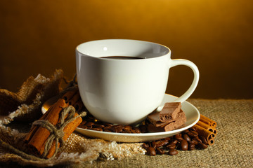 Obraz na płótnie Canvas cup of coffee and beans, cinnamon sticks and chocolate