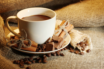 cup of coffee and beans, cinnamon sticks and chocolate