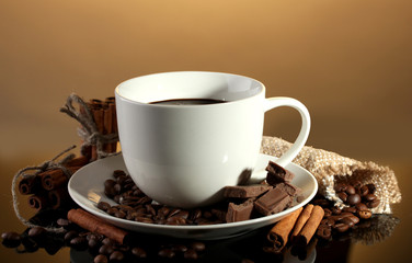 cup of coffee and beans, cinnamon sticks and chocolate