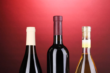 Bottles of great wine on red background