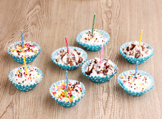 Creamy cupcakes on wooden background