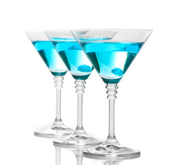 Blue cocktail in martini glasses isolated on white
