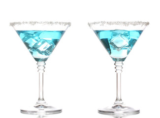 Blue cocktail in martini glasses isolated on white