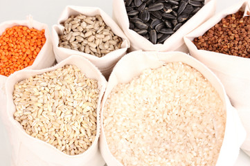 Cloth bags with grain close-up isolated on white