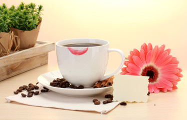 cup of coffee with lipstick mark and gerbera beans, cinnamon