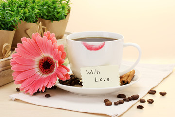 cup of coffee with lipstick mark and gerbera beans, cinnamon