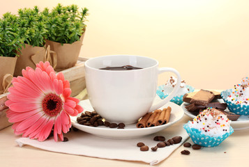 cup of coffee and gerbera  beans, cinnamon sticks