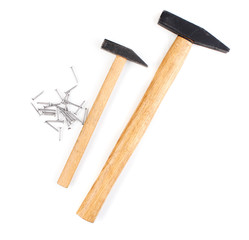 Hammers and metal nails isolated on white