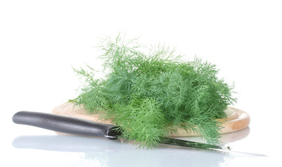 Dill on a cutting board with knife isolated on white
