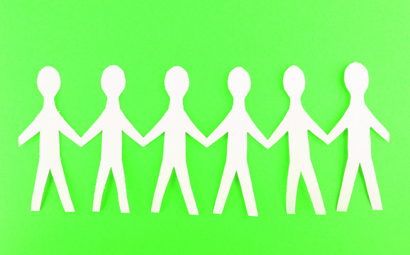 Paper people on green background