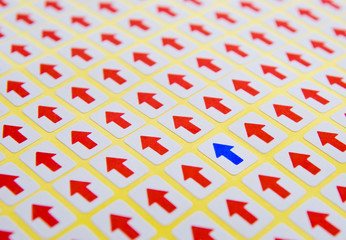 blue arrow stands out of red arrows