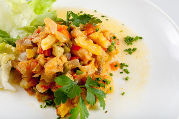 Fish and vegetables on white plate