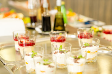 Creamy cup desserts on silver tray cafeteria