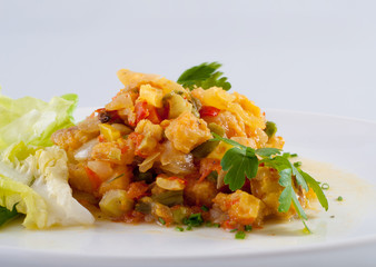 Fish and vegetables on white plate