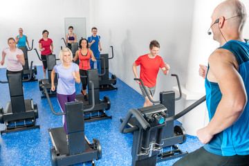 Class of young adults with fitness trainer