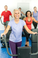 Fototapeta na wymiar Young fitness woman at treadmill running class
