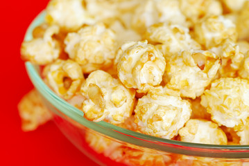 Popcorn in the bowl on red background
