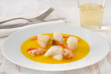 fish with shrimps in sauce on the plate