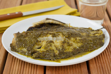fish with sauce pesto on th plate