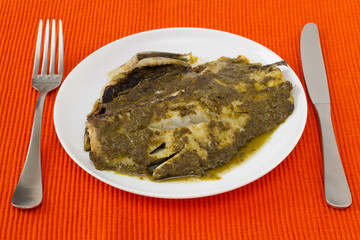 fish with sauce pesto on th plate