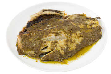 fish with sauce pesto on th plate
