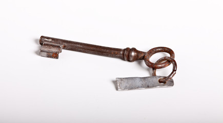 old rusty key over white background