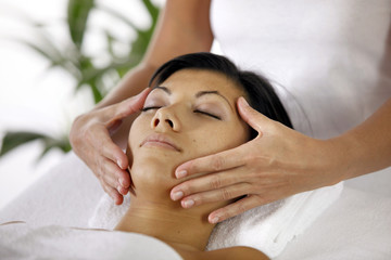 Fototapeta na wymiar Masseuse giving face massage
