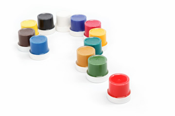 Question mark made from the cans of paint on a white background.