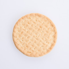 A round biscuit on a grey background