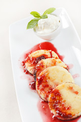 Cheese pancakes with cherry sauce