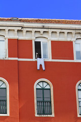 Red Mediteranean house and Long underwear hanging to dry