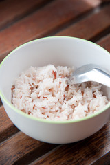 White and brown steamed rice in white round bowl