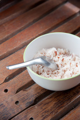 White and brown steamed rice in white round bowl