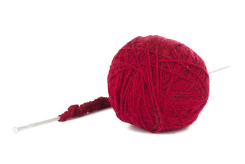 Knitting needles and red ball of yarn