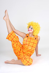 Clown in colourful costume doing gymnastic