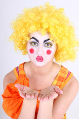 Clown in colourful costume showing hands